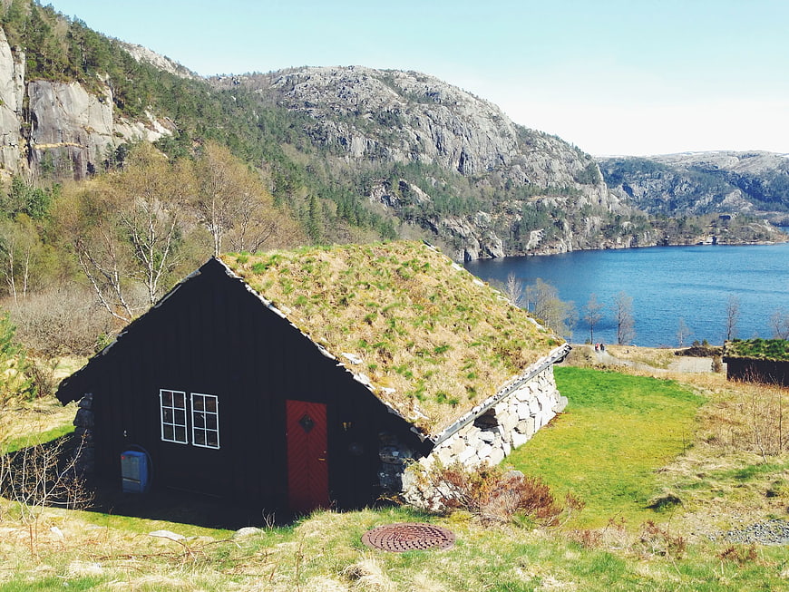 Traditional turf-roofed cabin by a fjord