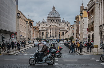 Street view of St. Peter's Basilica in Vatican City with traffic