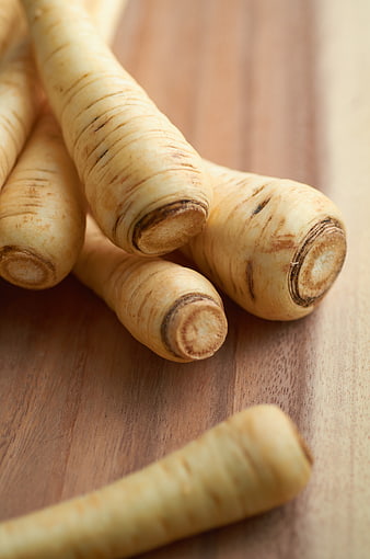 Fresh Raw Parsnips on Wooden Cutting Board