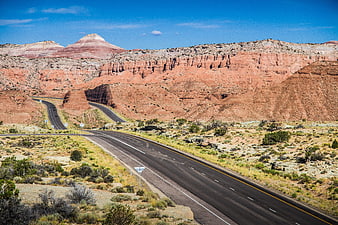 Winding desert highway through red rock canyon landscape