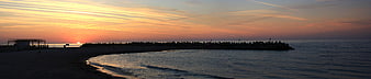 Panoramic Sunrise Over Beach Breakwater Silhouette