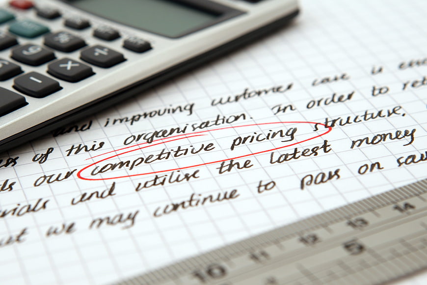 Calculator and ruler on handwritten business notes