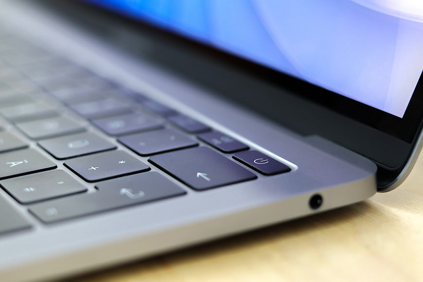 Close-up of silver laptop keyboard and power button