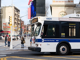 New York City Bus on Urban Street Corner