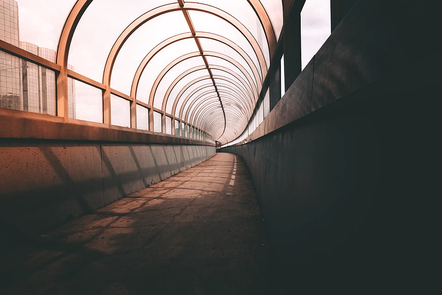 Modern Glass Canopy Walkway with Arched Metal Structure