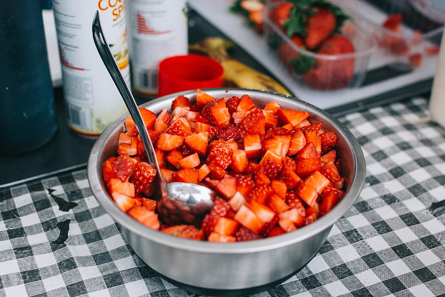 Bowl of Chopped Strawberries on Checkered Tablecloth