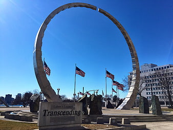 Transcending Monument Arch with American Flags and Blue Sky