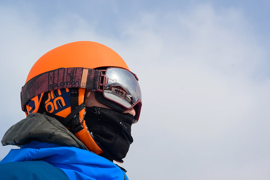 Skier in Orange Helmet and Blue Jacket with Goggles