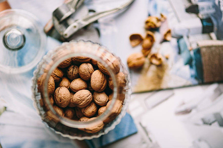 Top View of Walnuts in Glass Jar with Cracker