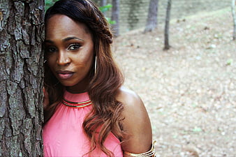 Portrait of Woman in Pink Dress Leaning Against Tree
