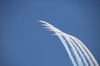 Red Arrows aerobatic team flying in formation with smoke trails