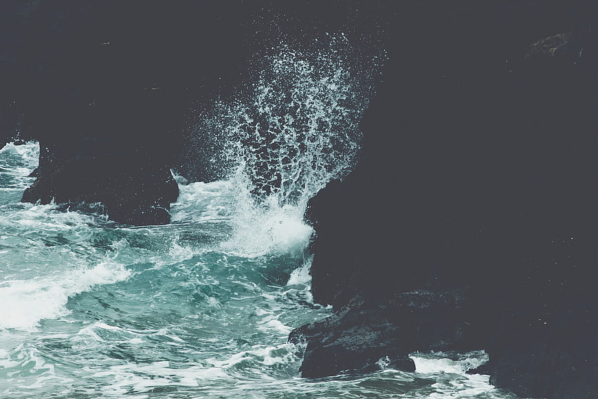 Dramatic Ocean Waves Crashing Against Dark Rocks