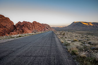 Desert Highway at Sunset with Red Rock Formations