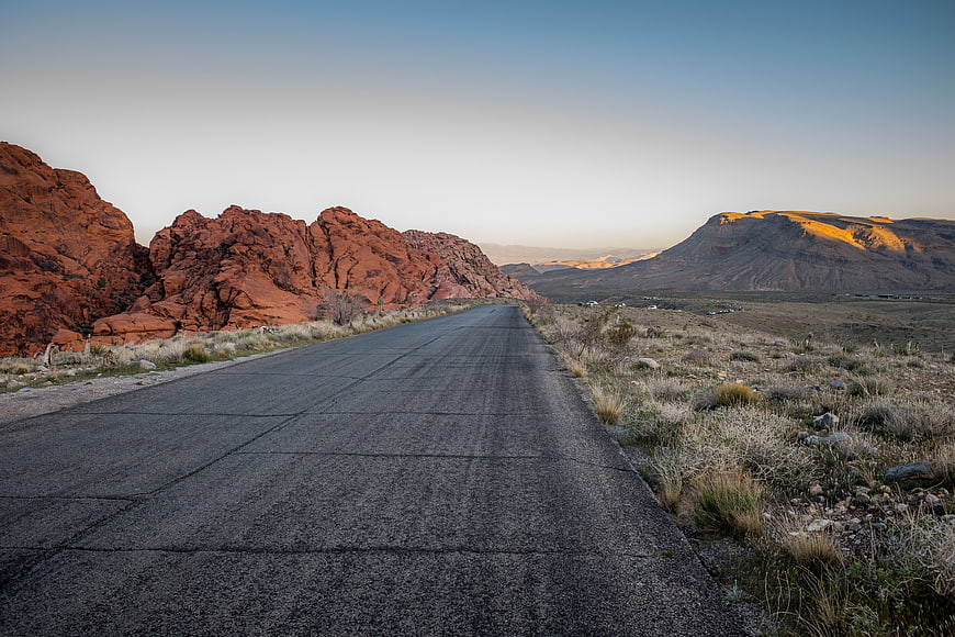 Desert Highway at Sunset with Red Rock Formations