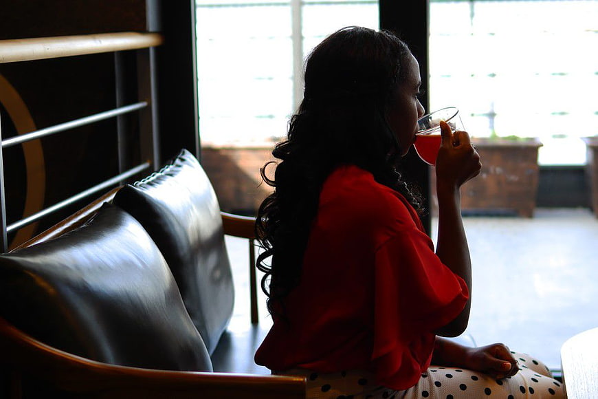 Woman in Red Shirt Drinking Tea by Window