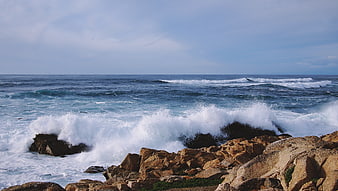 Powerful Ocean Waves Crashing Against Rocky Coastline