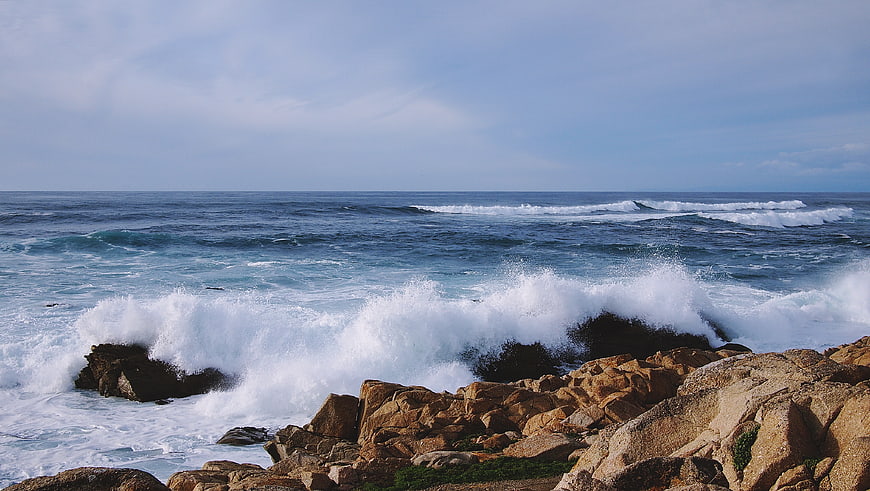 Powerful Ocean Waves Crashing Against Rocky Coastline