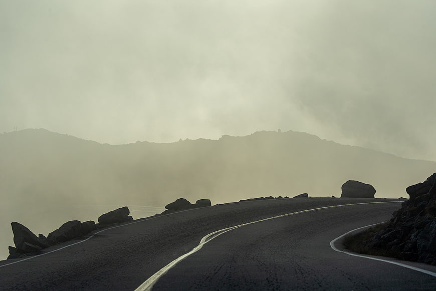 Misty Winding Mountain Road with Foggy Landscape