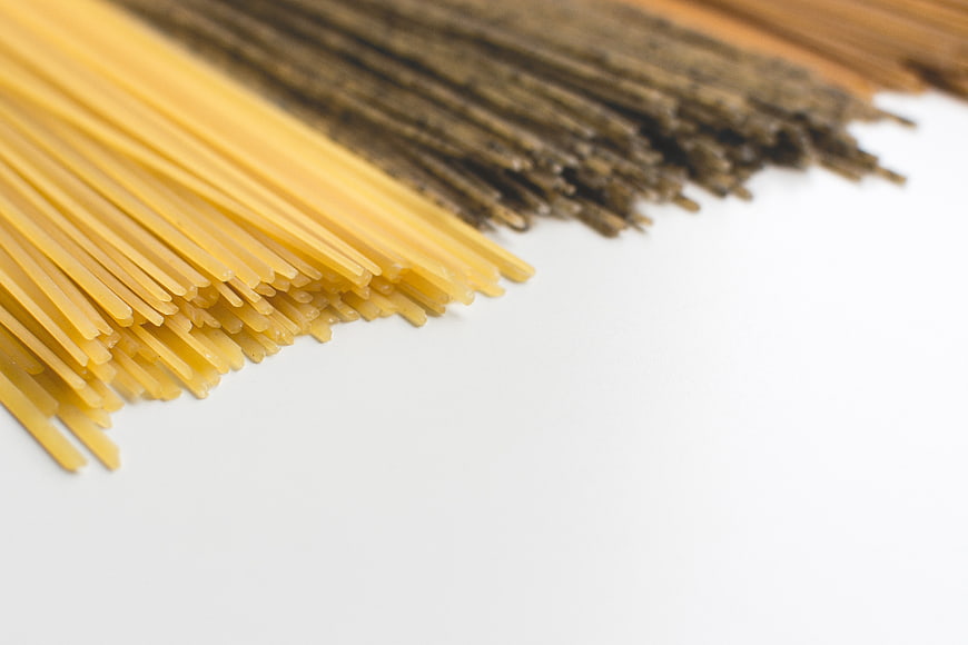 Uncooked Tricolor Spaghetti on White Background
