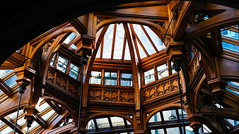 Ornate wooden architecture interior with arched glass windows