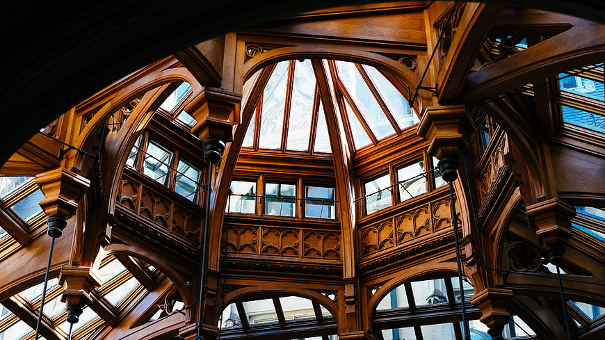 Ornate wooden architecture interior with arched glass windows