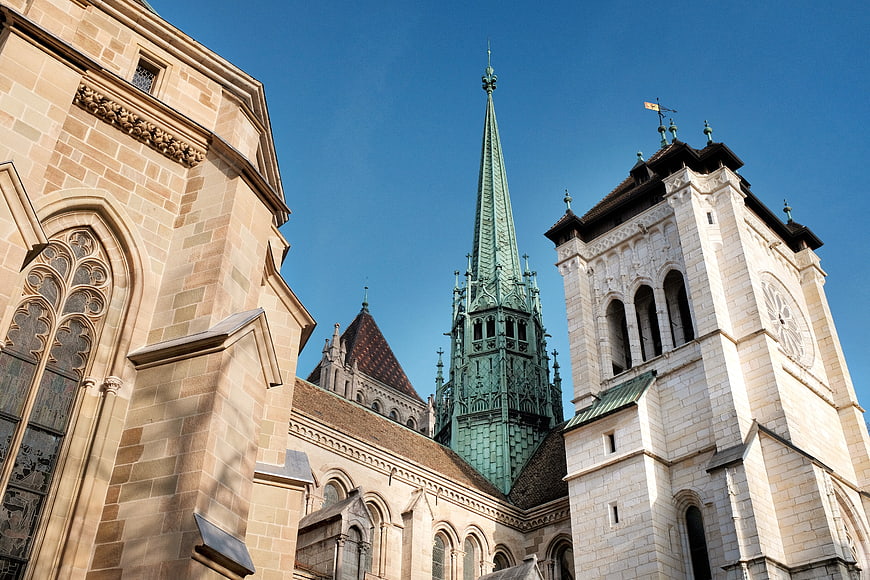 Gothic Cathedral Architecture with Green Spire and Stone Towers