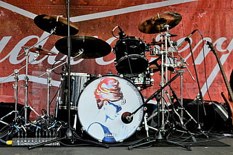 Empty Drum Set on Stage with Red Backdrop