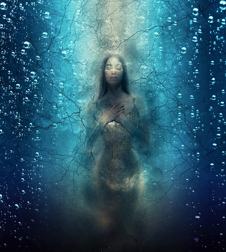 Ethereal woman in blue underwater environment with bubbles and cracks