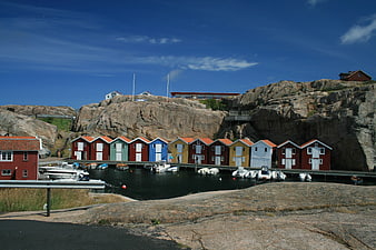 Colorful boathouses on rocky Swedish coastline