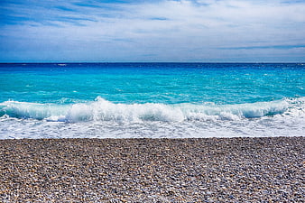 Turquoise Mediterranean Sea Waves Breaking On Pebble Beach