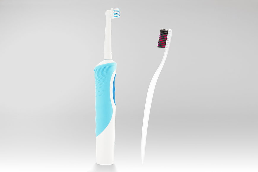 Electric and Manual Toothbrushes on White Background