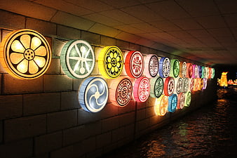 Colorful Round Lanterns on Stone Wall at Night