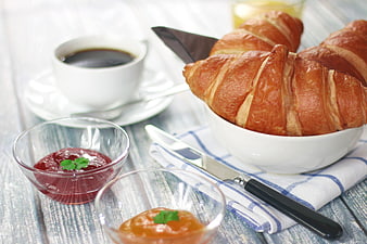 Fresh Croissants with Coffee and Jam on Rustic Table