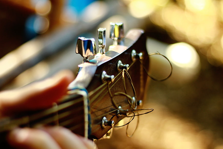 Close-up of Guitar Headstock with Tuning Pegs and Bokeh