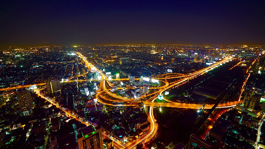 Aerial Night View of City Highway Interchange with Light Trails