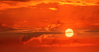 Vibrant Orange Sunset Sky with Sun and Clouds