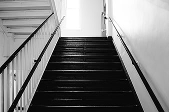 Black and white interior staircase with white walls