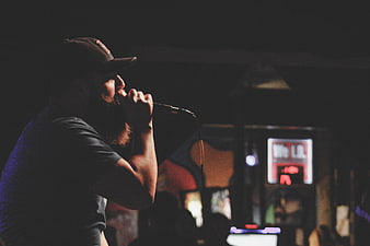 Bearded Male Singer Performing Live on Stage