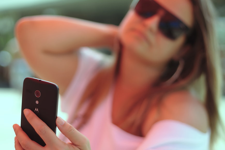 Woman Taking Selfie with Smartphone Outdoors