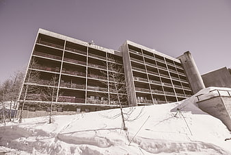 Modern Concrete Apartment Building in Snowy Winter Landscape