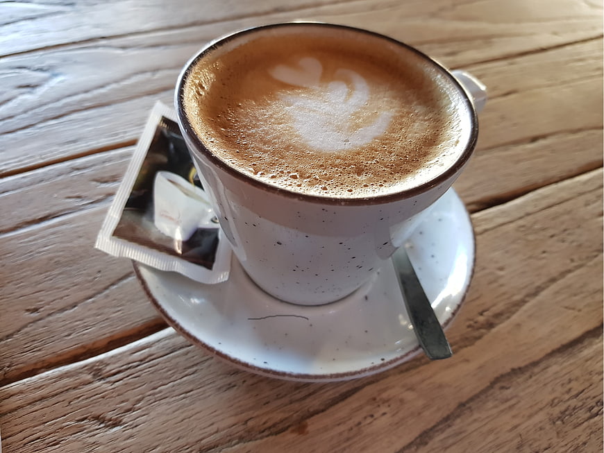 Latte Art Coffee Cup on Rustic Wooden Table