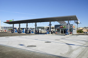 Modern Fuel Station With Blue Pumps And Concrete Forecourt