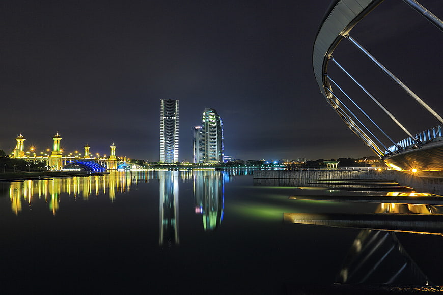 Modern City Skyline at Night with Water Reflections