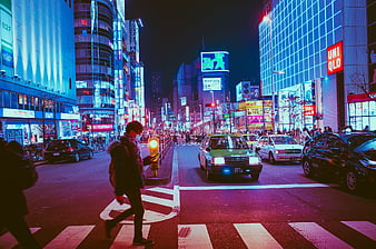Night street scene in Osaka Japan with neon lights and pedestrians