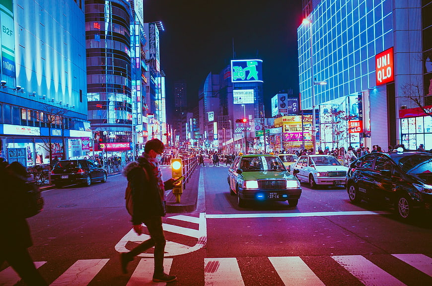 Night street scene in Osaka Japan with neon lights and pedestrians