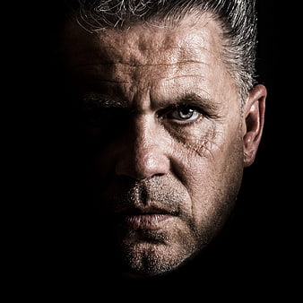 Dramatic Close-Up Portrait of Mature Man in Shadows
