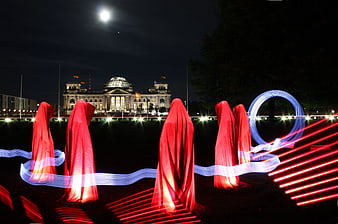 Red draped figures with light painting in front of Reichstag Berlin