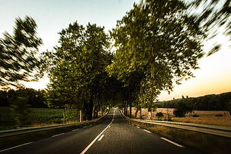 Motion blur view of rural road at sunset