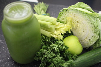 Fresh green juice with celery, cabbage, apple, and parsley