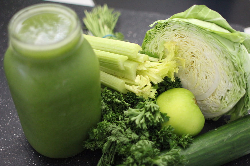 Fresh green juice with celery, cabbage, apple, and parsley